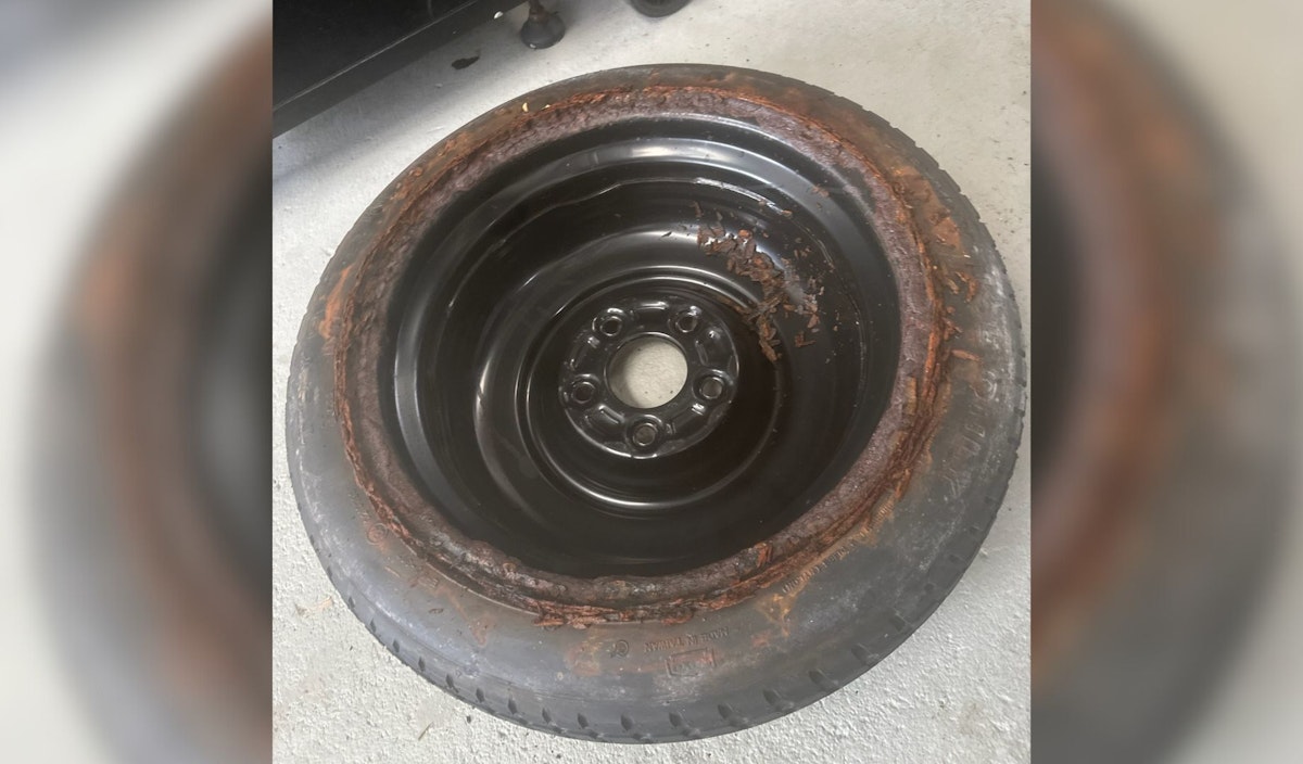 Rusted rim and tyre from flooded boot